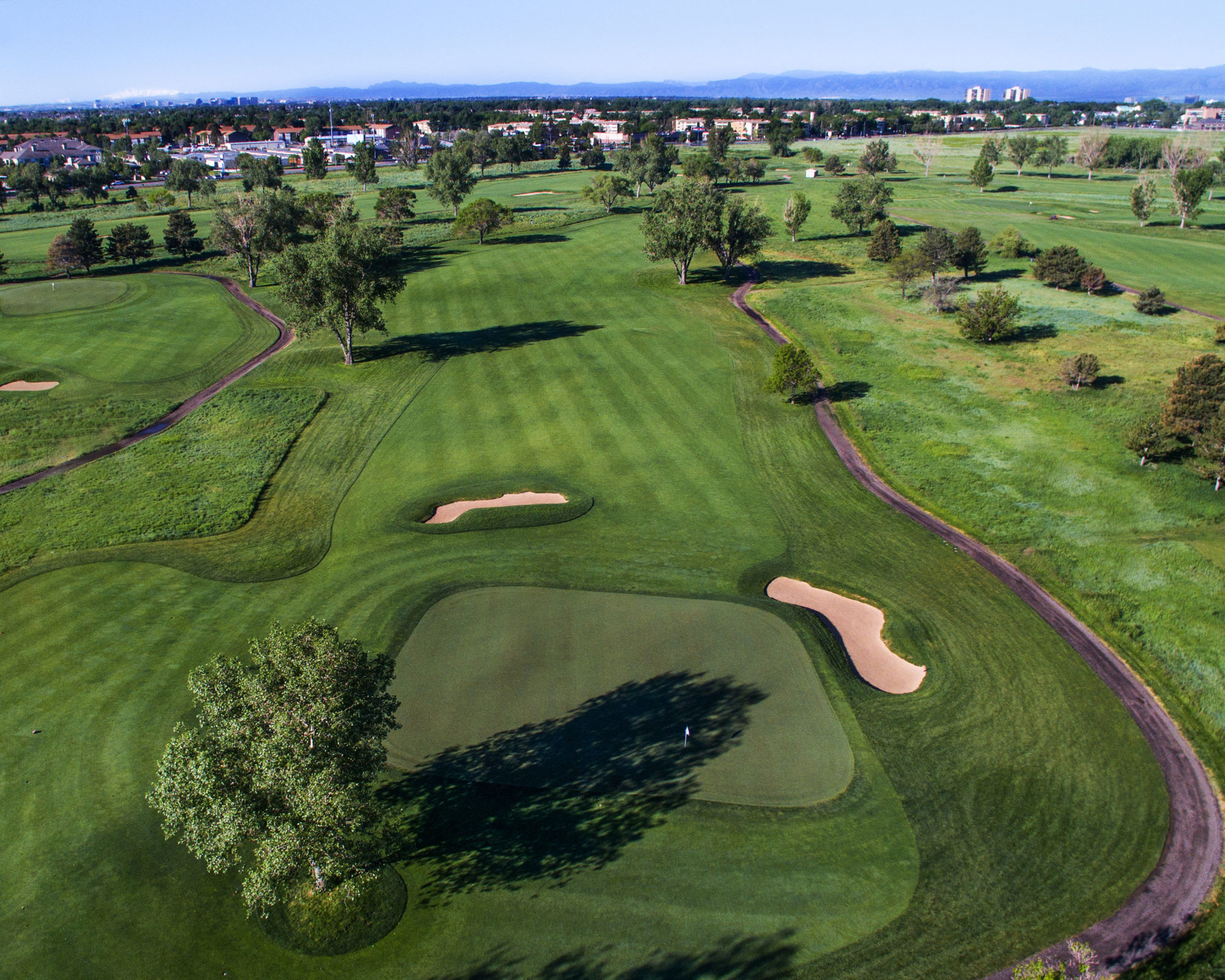 The par-4 16th uses trees at the corner of the dogleg to keep long hitters in check despite the mile high altitude.