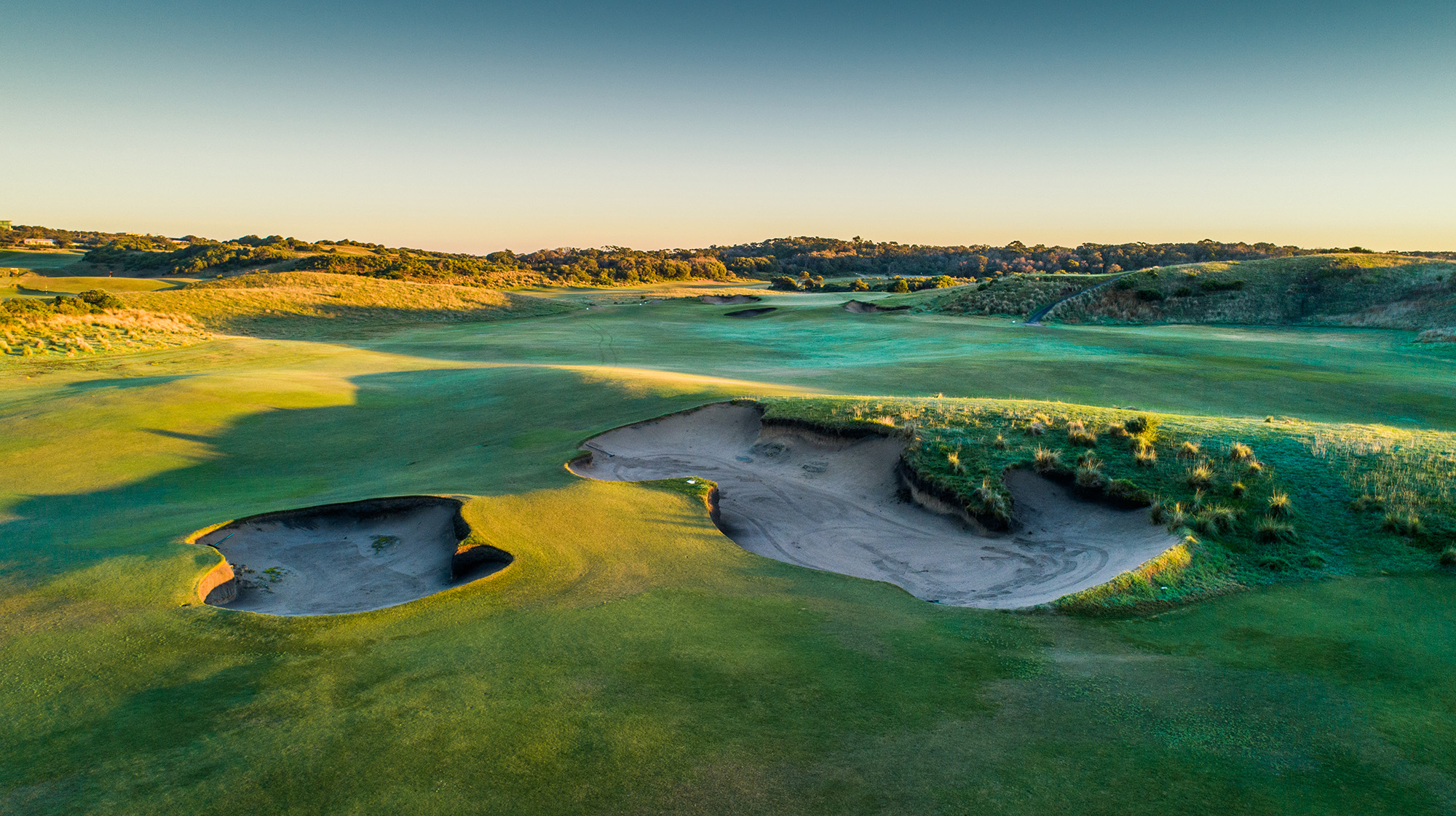 First morning light on the bunker complex which divides the shared fairway of the 7th and 8th holes.