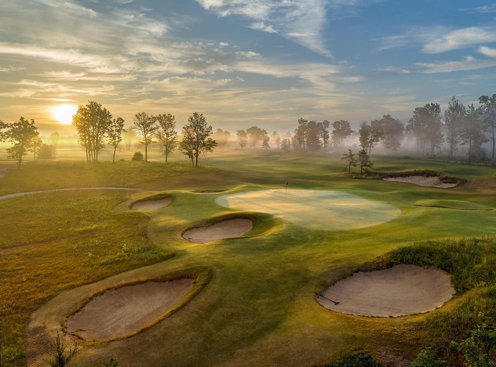 Sunrise on a misty and mystical morning at The Loop at Forest Dunes.  This view is looking back over the 12th green on the Black Course which also serves at the 6th green of the Red Course.  A wonderful reversible golf course designed by tom doak.